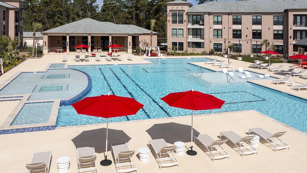 Property resort style pool cabanas, in water loungers, and social areas