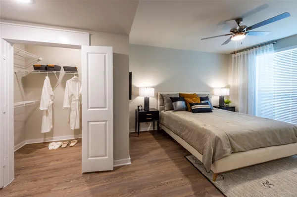 a bedroom with a bed and a mirror