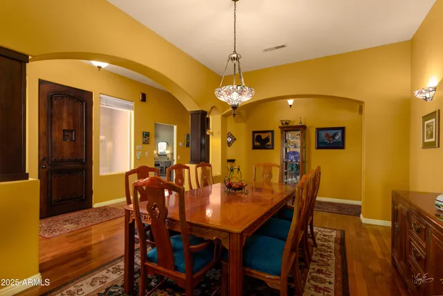 a dining room with a table chairs and a chandelier