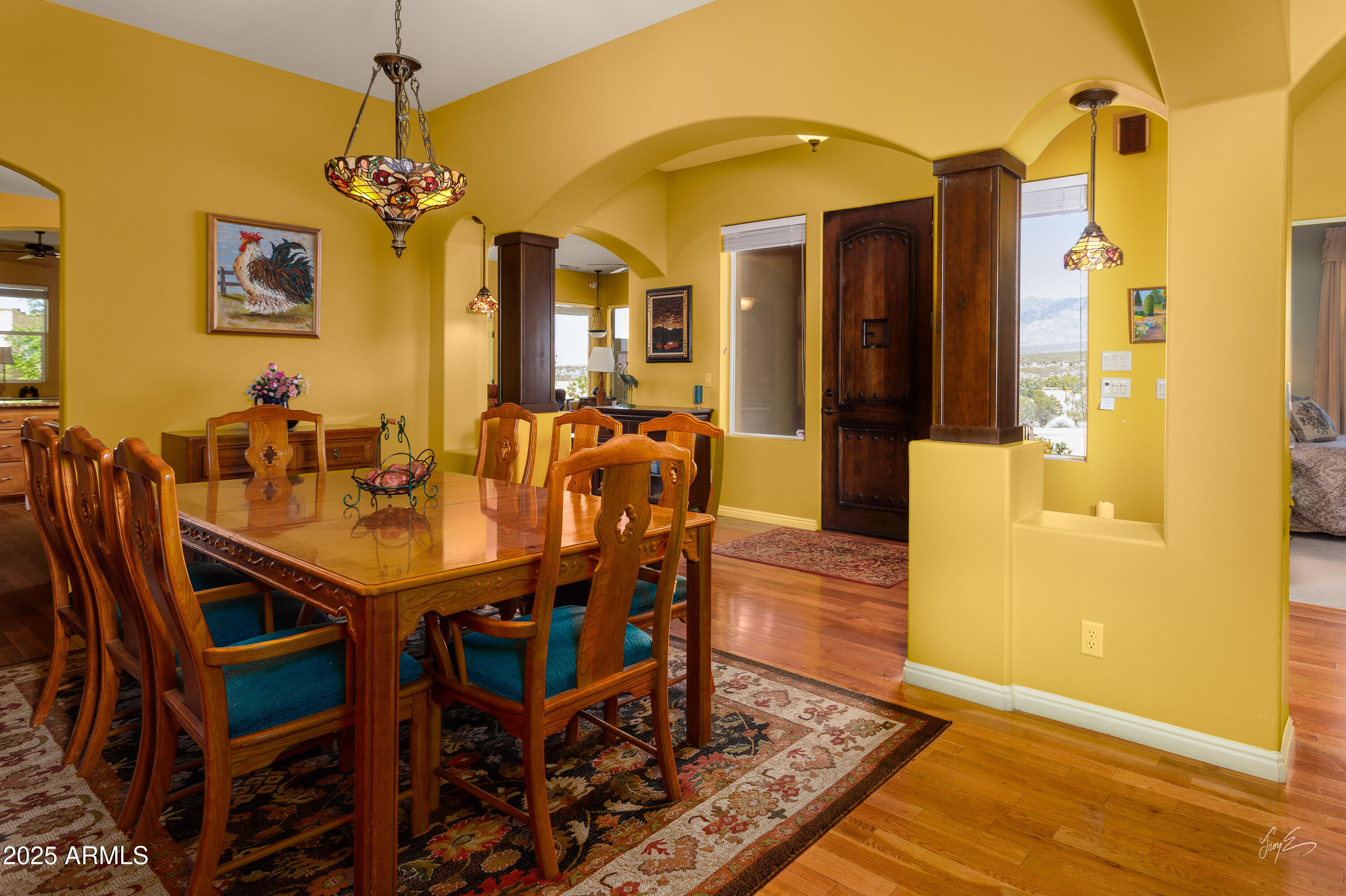 2601 South Frehner Road Littlefield, AZ 86432 - Photo 15 of 32 a dining room with a table chairs and a chandelier