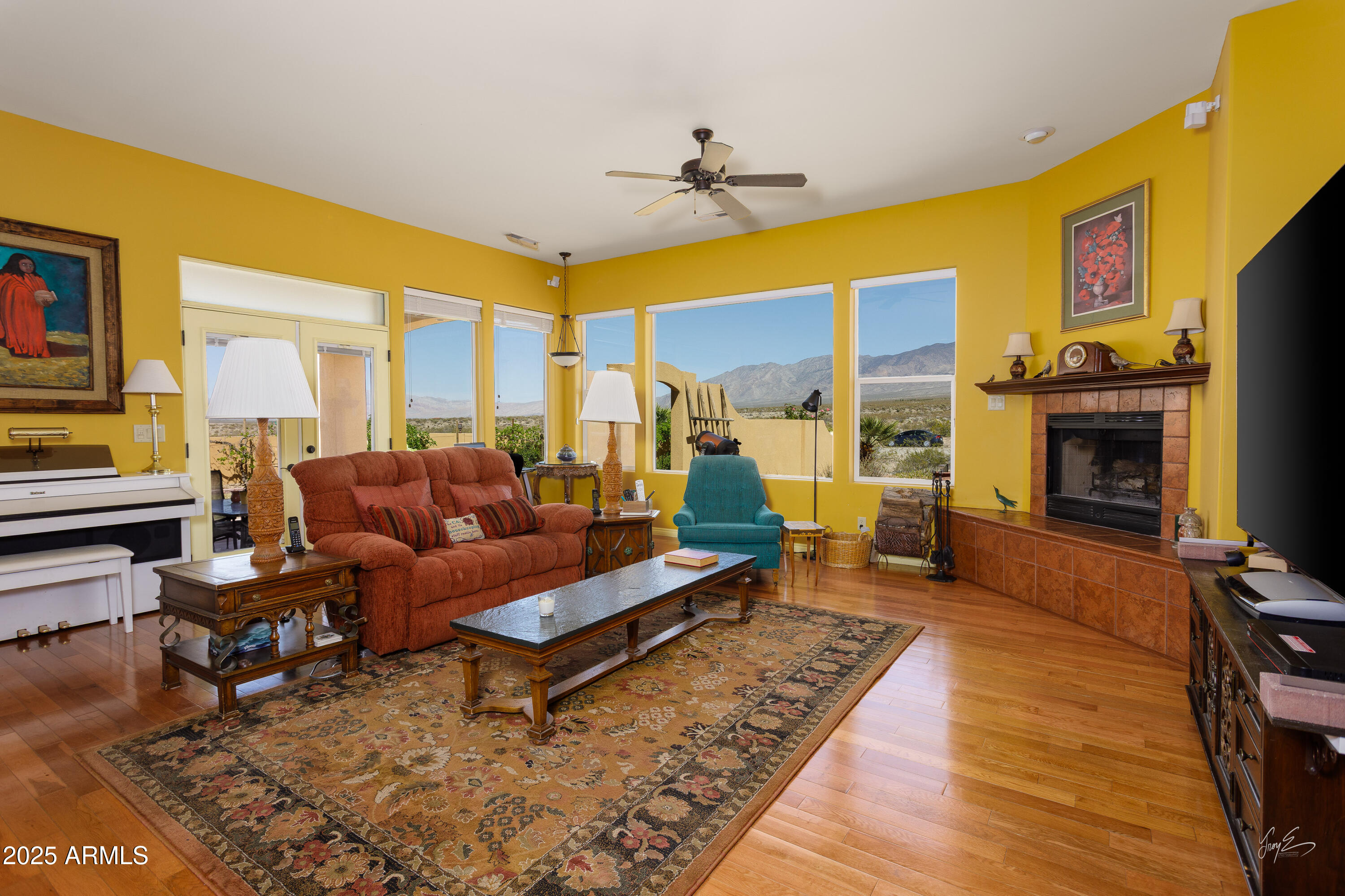 2601 South Frehner Road Littlefield, AZ 86432 - Photo 4 of 32 a living room with furniture a fireplace and a flat screen tv