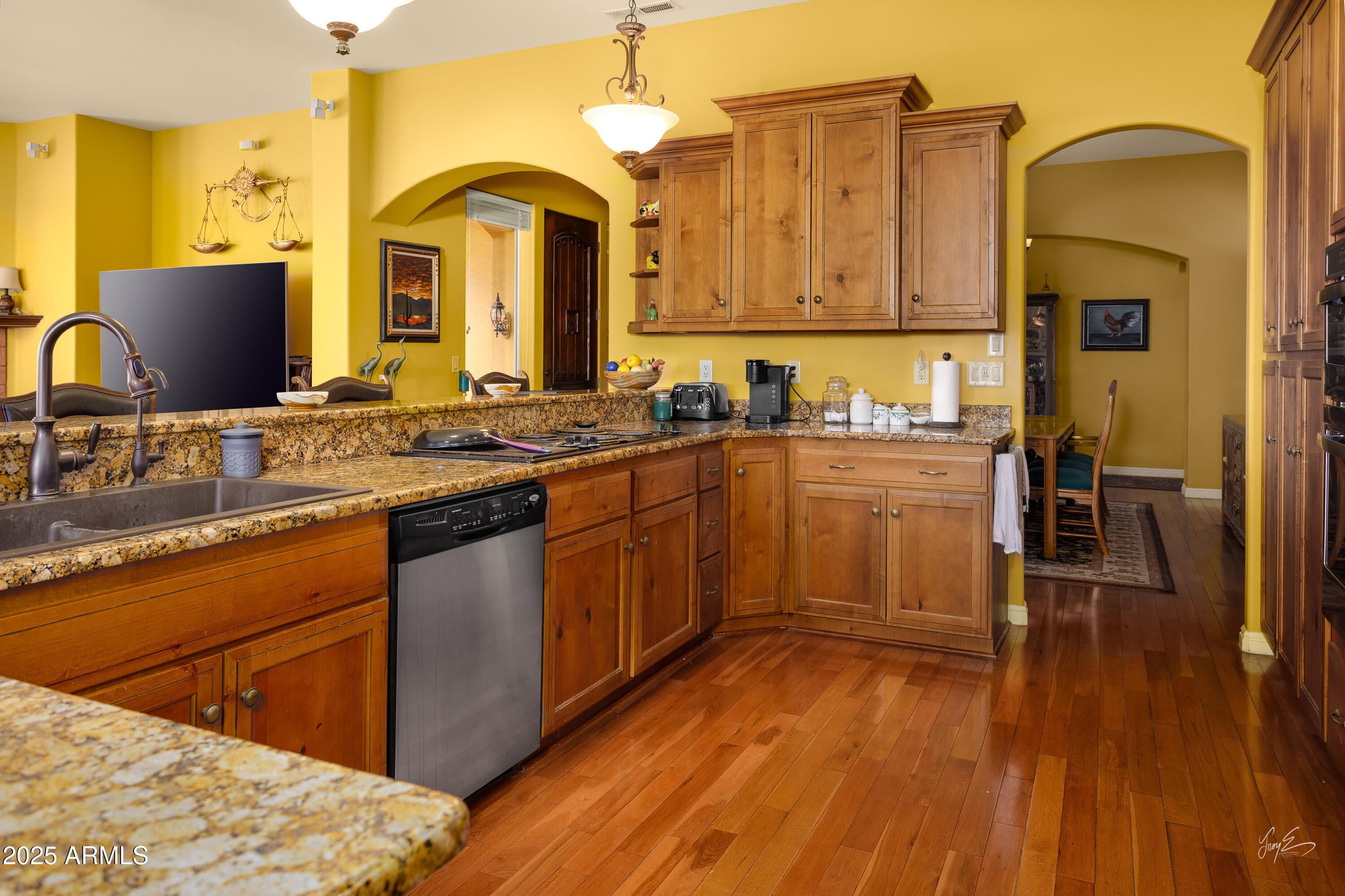 2601 South Frehner Road Littlefield, AZ 86432 - Photo 7 of 32 a kitchen with stainless steel appliances granite countertop wooden cabinets a sink dishwasher a stove and a refrigerator