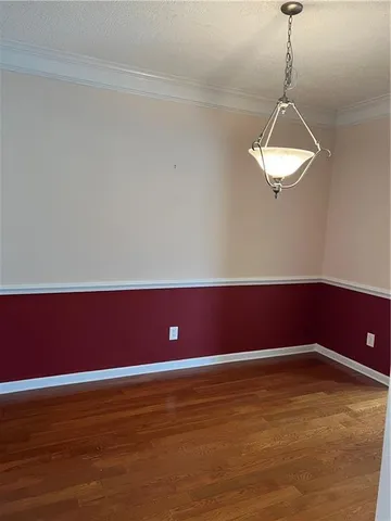 a view of a room with wooden floor and window