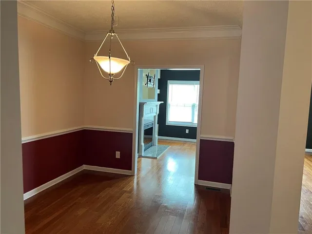 a view of a room with wooden floor and staircase