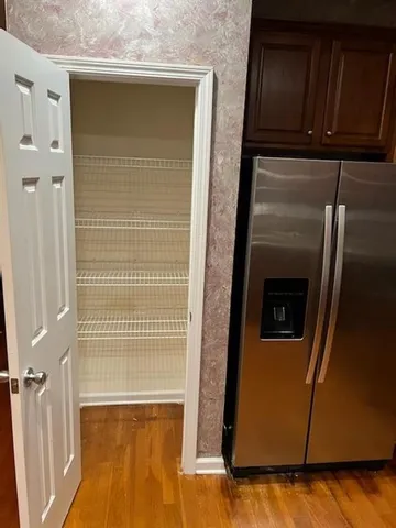 a view of kitchen with granite countertop cabinets and sink