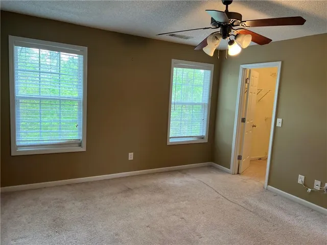 a view of a room with window and a ceiling fan