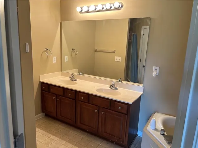a bathroom with a bathtub and a sink