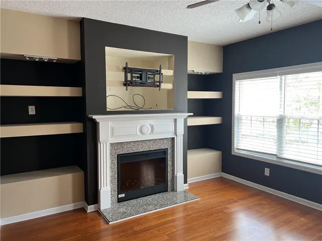 a living room with a fireplace and a window
