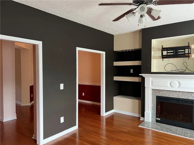 a view of a livingroom with an empty space and a fireplace