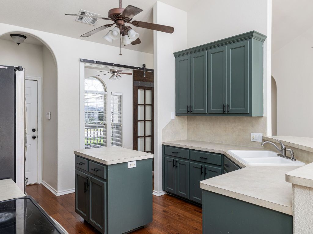 2209 Lark Lane Taylor, TX 76574 - Photo 13 of 25 a kitchen with a stove and a sink