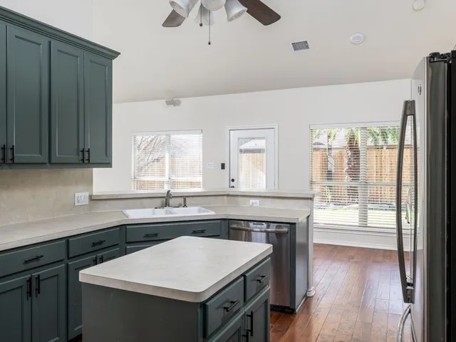 a kitchen with a sink and wooden cabinets