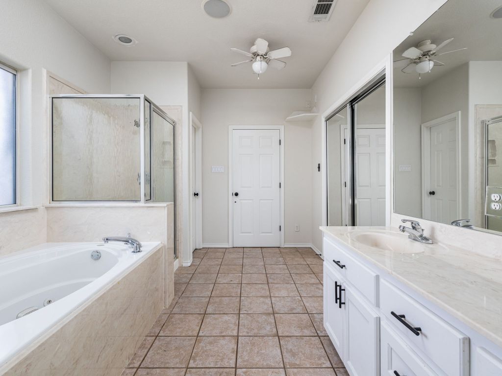 2209 Lark Lane Taylor, TX 76574 - Photo 18 of 25 a spacious bathroom with a tub sink and mirror