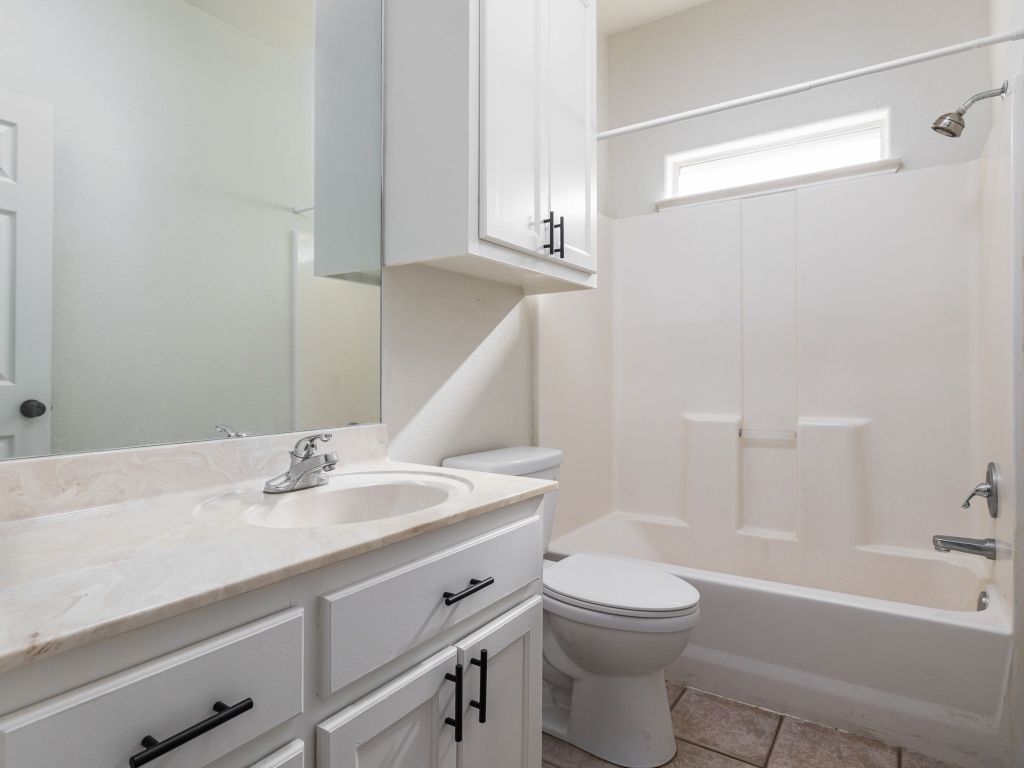 2209 Lark Lane Taylor, TX 76574 - Photo 22 of 25 a bathroom with a sink a toilet and shower