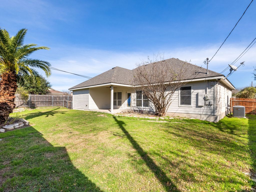 2209 Lark Lane Taylor, TX 76574 - Photo 4 of 25 a front view of a house with a garden