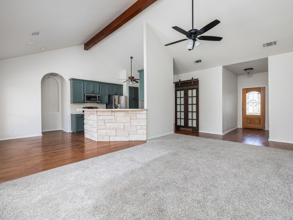 2209 Lark Lane Taylor, TX 76574 - Photo 9 of 25 a view of a kitchen with a sink hardwood floor and a ceiling fan