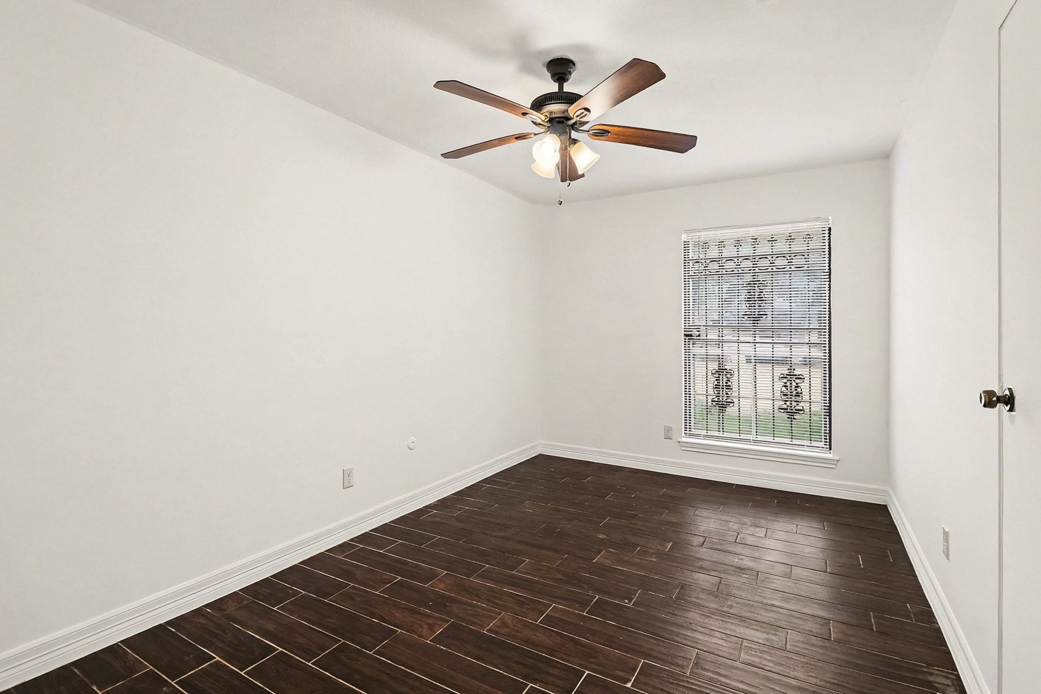 8138 Constellation Lane Houston, TX 77075 - Photo 11 of 16 wooden floor in an empty room with a window
