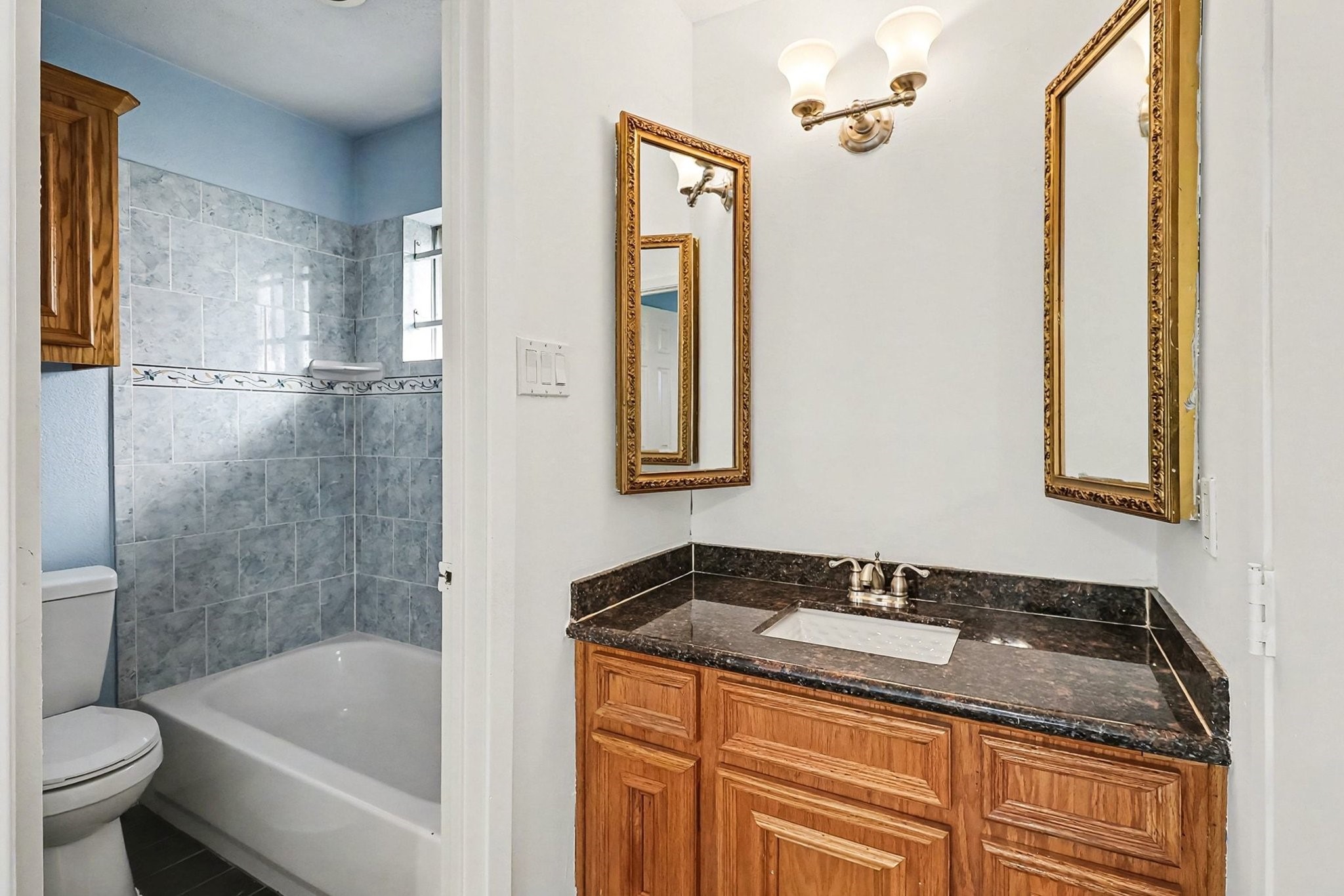 8138 Constellation Lane Houston, TX 77075 - Photo 13 of 16 a bathroom with a granite countertop sink toilet and shower