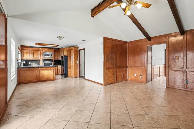 a view of a kitchen with a refrigerator and a sink