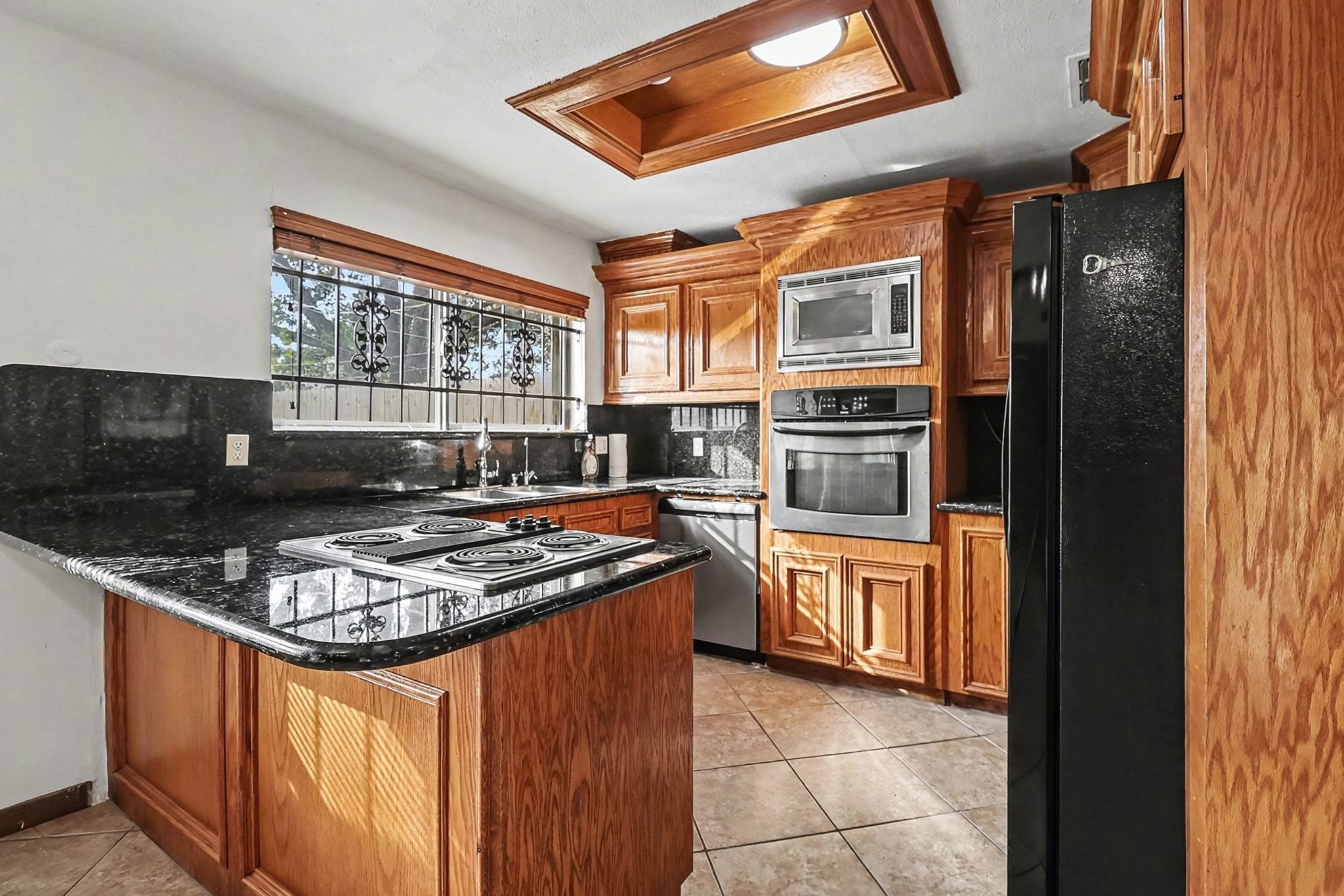 8138 Constellation Lane Houston, TX 77075 - Photo 7 of 16 a kitchen with stainless steel appliances granite countertop a stove sink and refrigerator