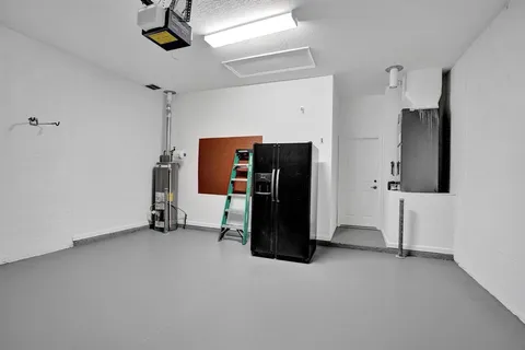 a living room with lots of furniture and white walls