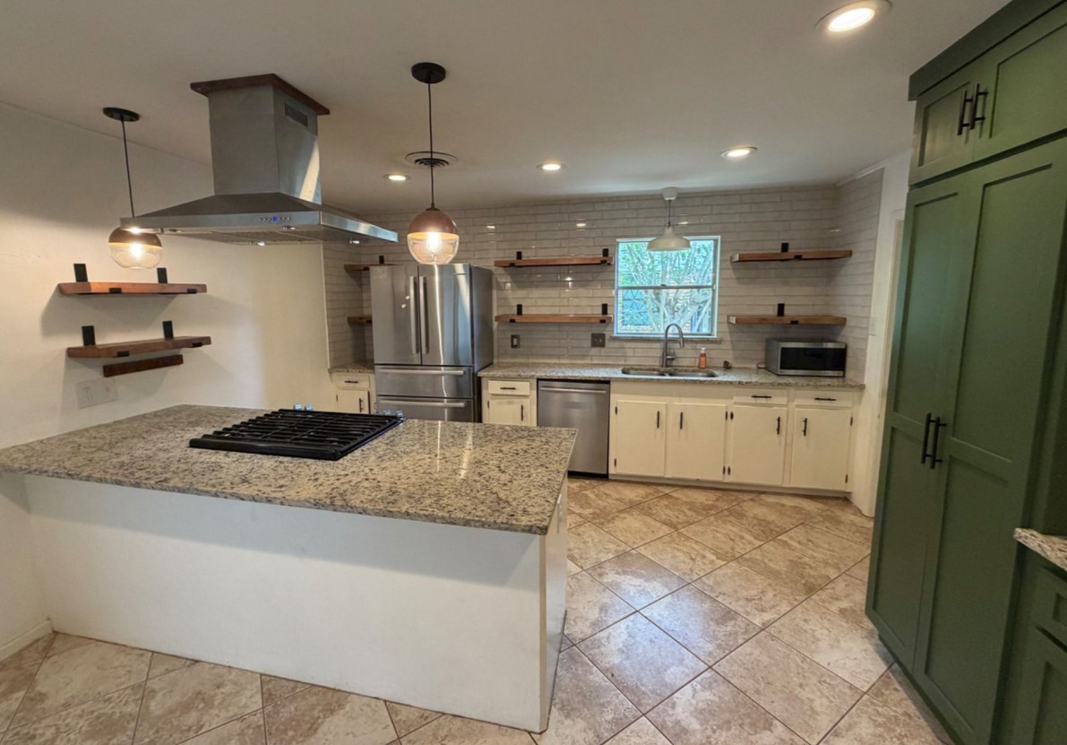 7314 Cannock Road Houston, TX 77074 - Photo 3 of 6 a kitchen with stainless steel appliances granite countertop a sink a stove and a refrigerator