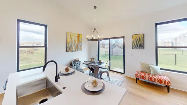 a kitchen with kitchen island stainless steel appliances a sink stove and refrigerator