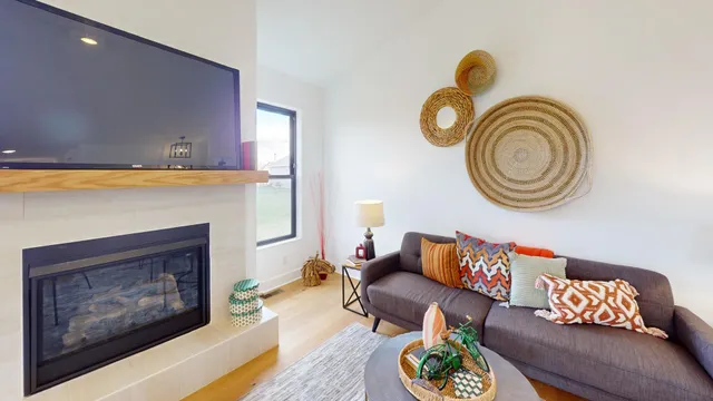 a living room with furniture a flat screen tv and a fireplace