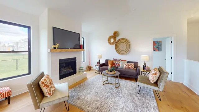 a living room with fireplace furniture and a flat screen tv