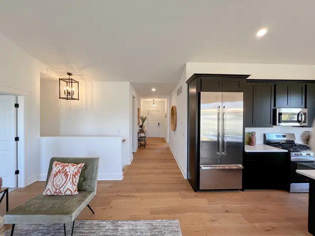 a kitchen with granite countertop a sink stove and refrigerator