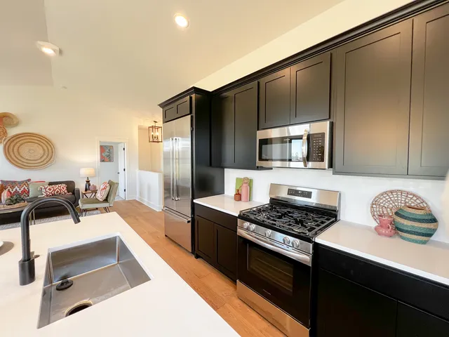 a view of a livingroom with wooden floor and furniture
