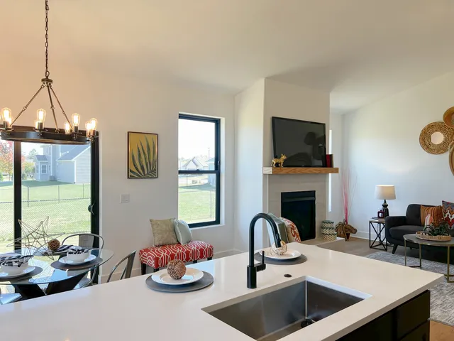 a view of a hallway with wooden floor and a living room