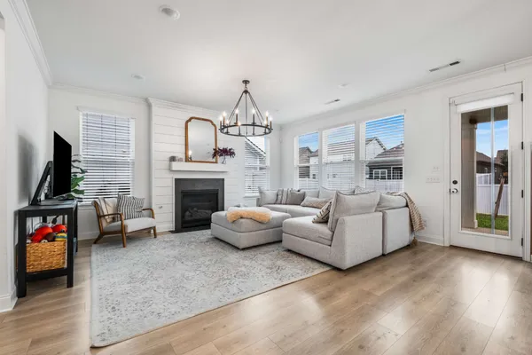 a living room with furniture a flat screen tv and a fireplace