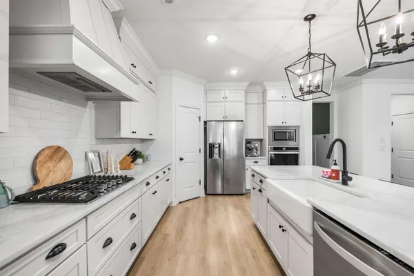 a kitchen with refrigerator a sink and cabinets