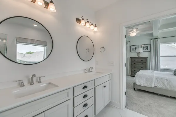 a en suite bathroom with double vanity sinks and a mirror