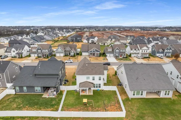 an aerial view of residential houses with yard