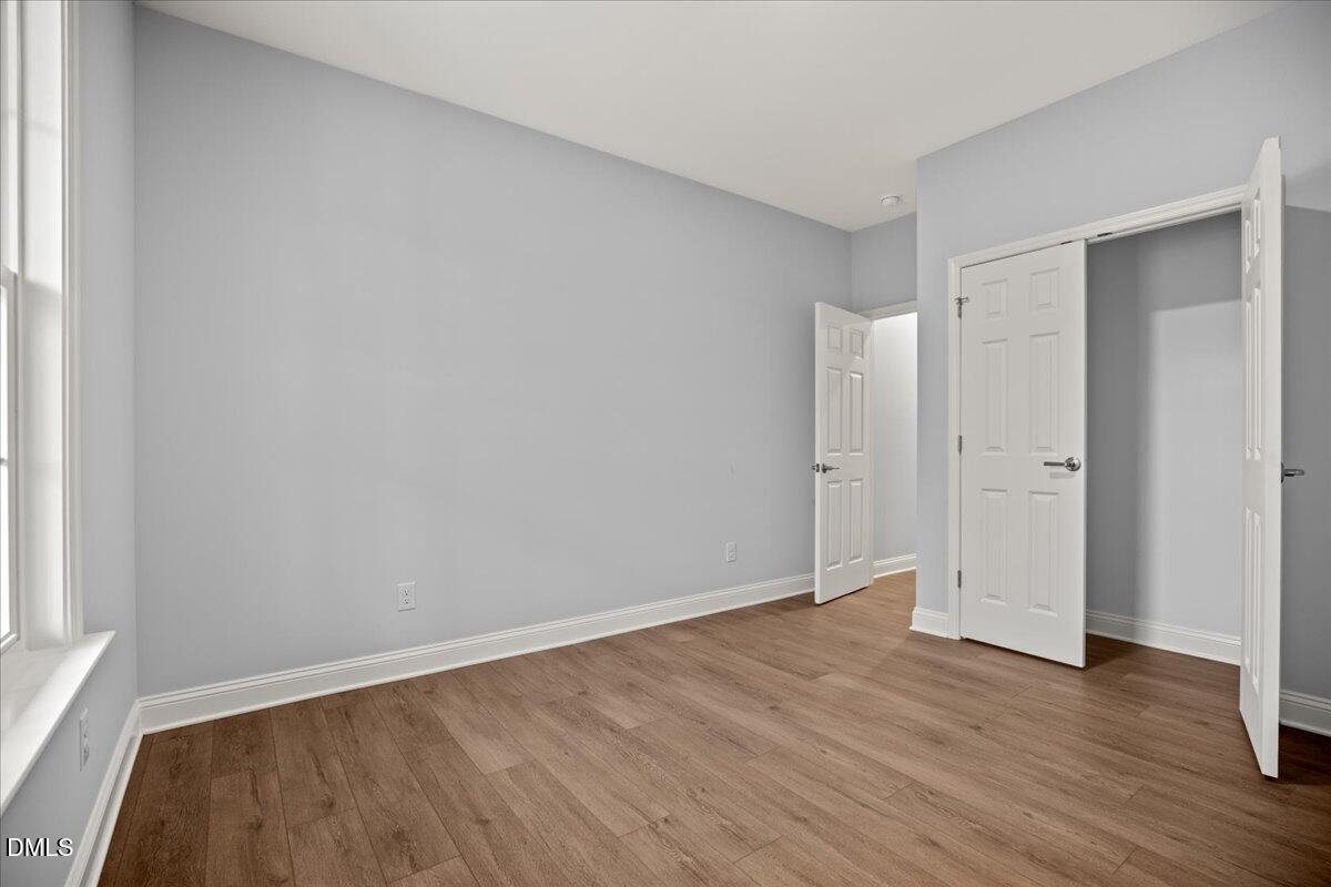 1300 Nick Coley Road Whitakers, NC 27891 - Photo 24 of 47 a view of an empty room with wooden floor and a window