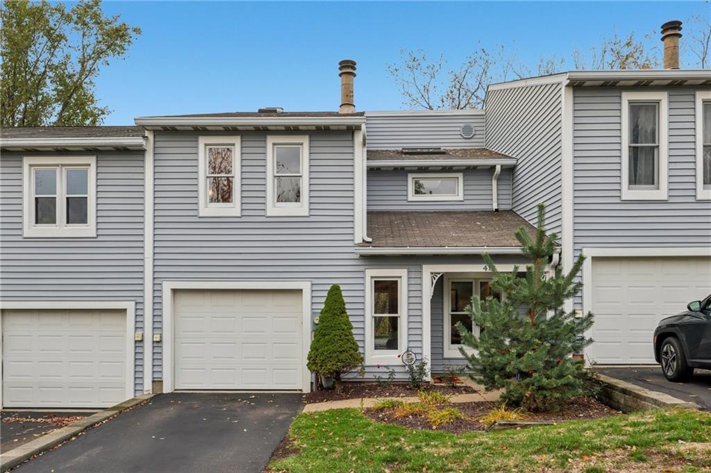 a view of a house with a yard and garage