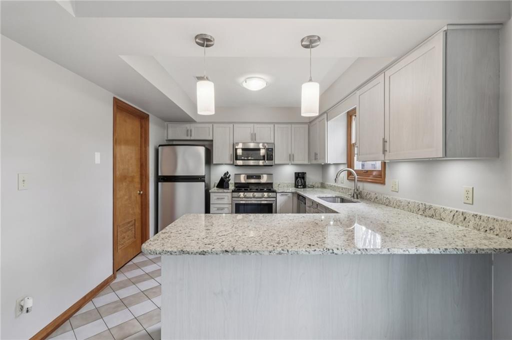 416 Chandler Place Pittsburgh, PA 15212 - Photo 14 of 38 a kitchen with granite countertop a sink a counter top space stainless steel appliances and cabinets