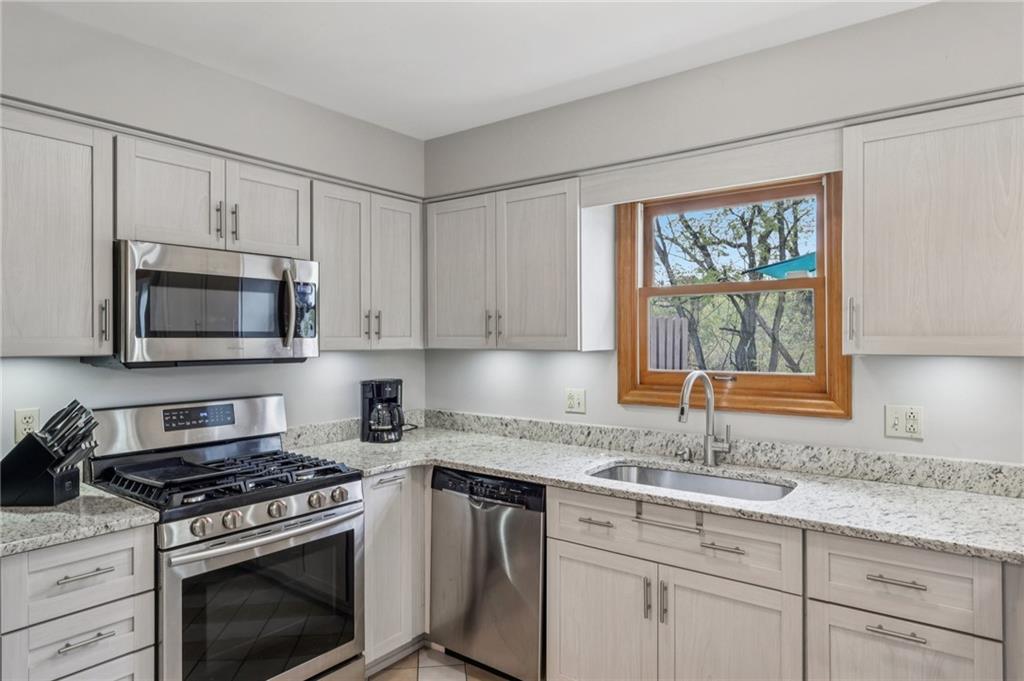 416 Chandler Place Pittsburgh, PA 15212 - Photo 17 of 38 a kitchen with granite countertop white cabinets and appliances