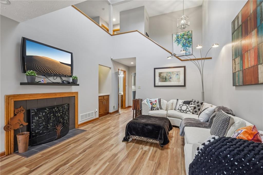 416 Chandler Place Pittsburgh, PA 15212 - Photo 6 of 38 a living room with furniture a flat screen tv and a fireplace