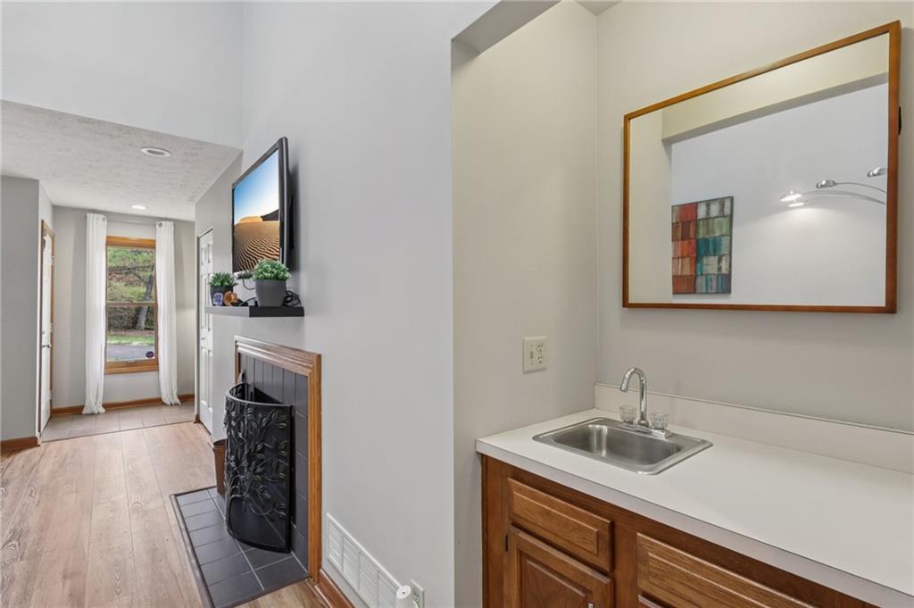 416 Chandler Place Pittsburgh, PA 15212 - Photo 9 of 38 a kitchen with a sink cabinets and a fireplace