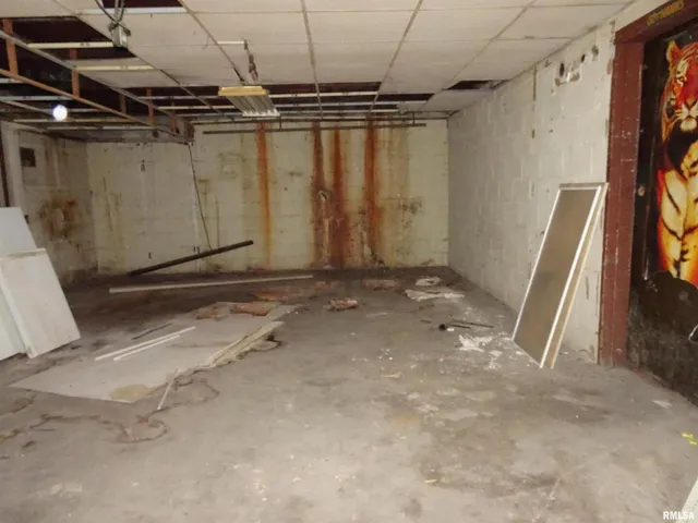 a hallway with a black white checkered floor and a cabinet