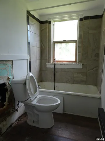 a view of a room with wooden floor and windows