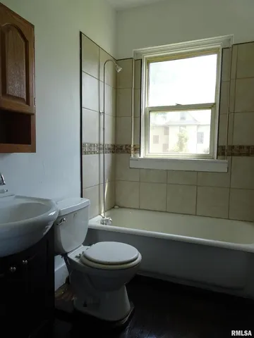 a bathroom with a toilet a sink and window