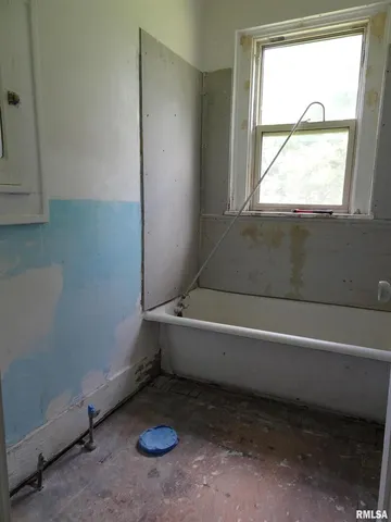 a view of a room with gym equipment and a window