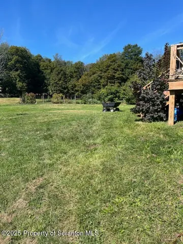 a view of a field with an ocean