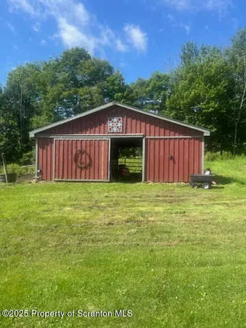 a view of a balcony with chair and wooden floor