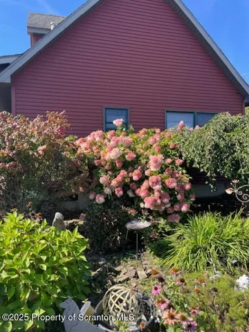 a view of a yard with a house in the background