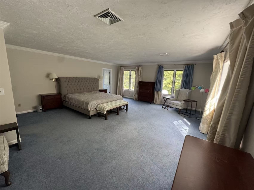 22 Capt Samuel Forbush Road Westborough, MA 01581 - Photo 12 of 38 a spacious bedroom with a bed couch and a window