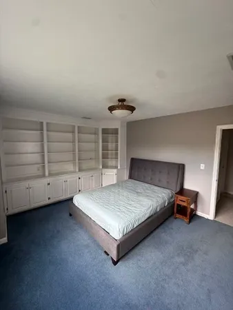 a living room with furniture and a ceiling fan